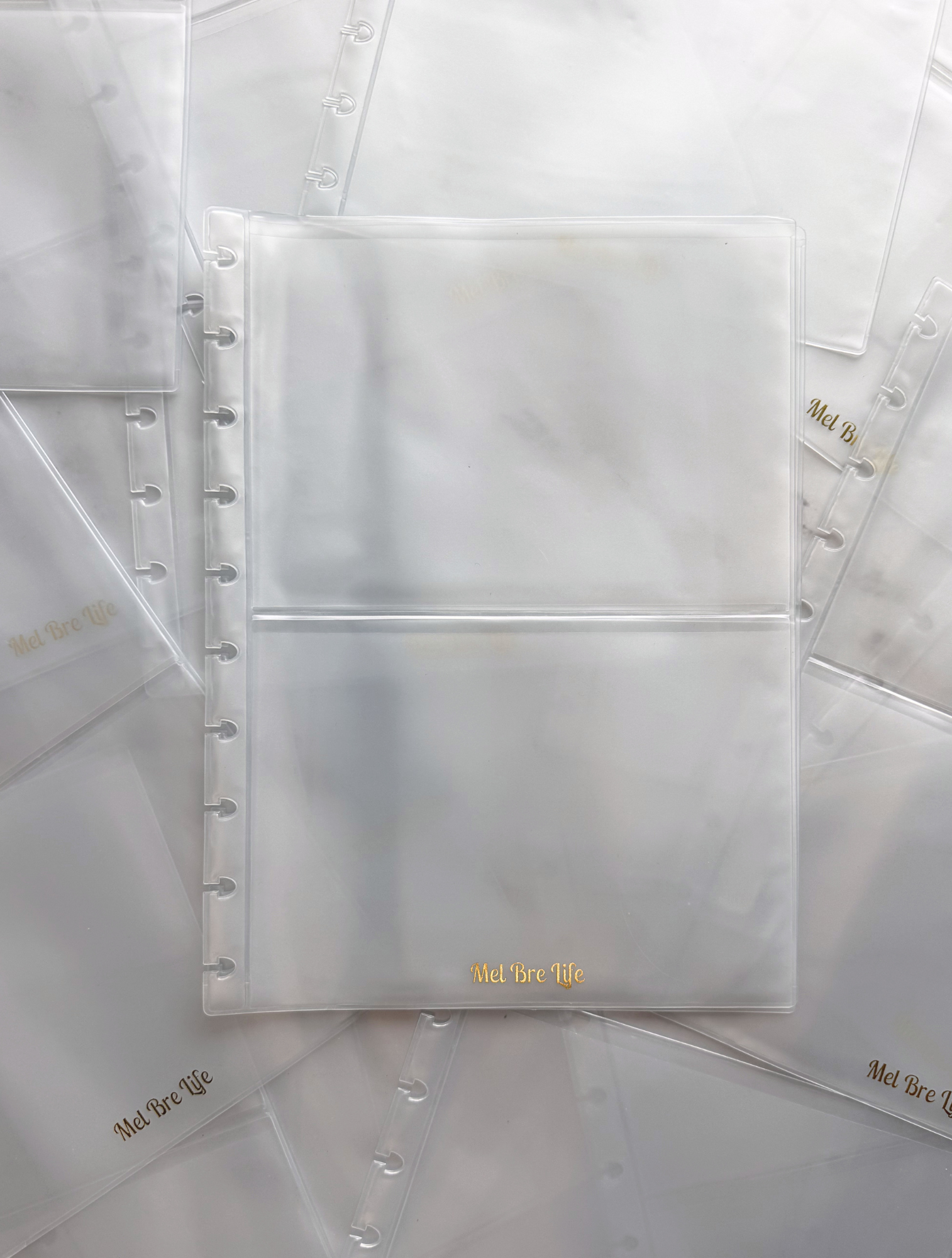 Clear plastic pages with gold text on a white background