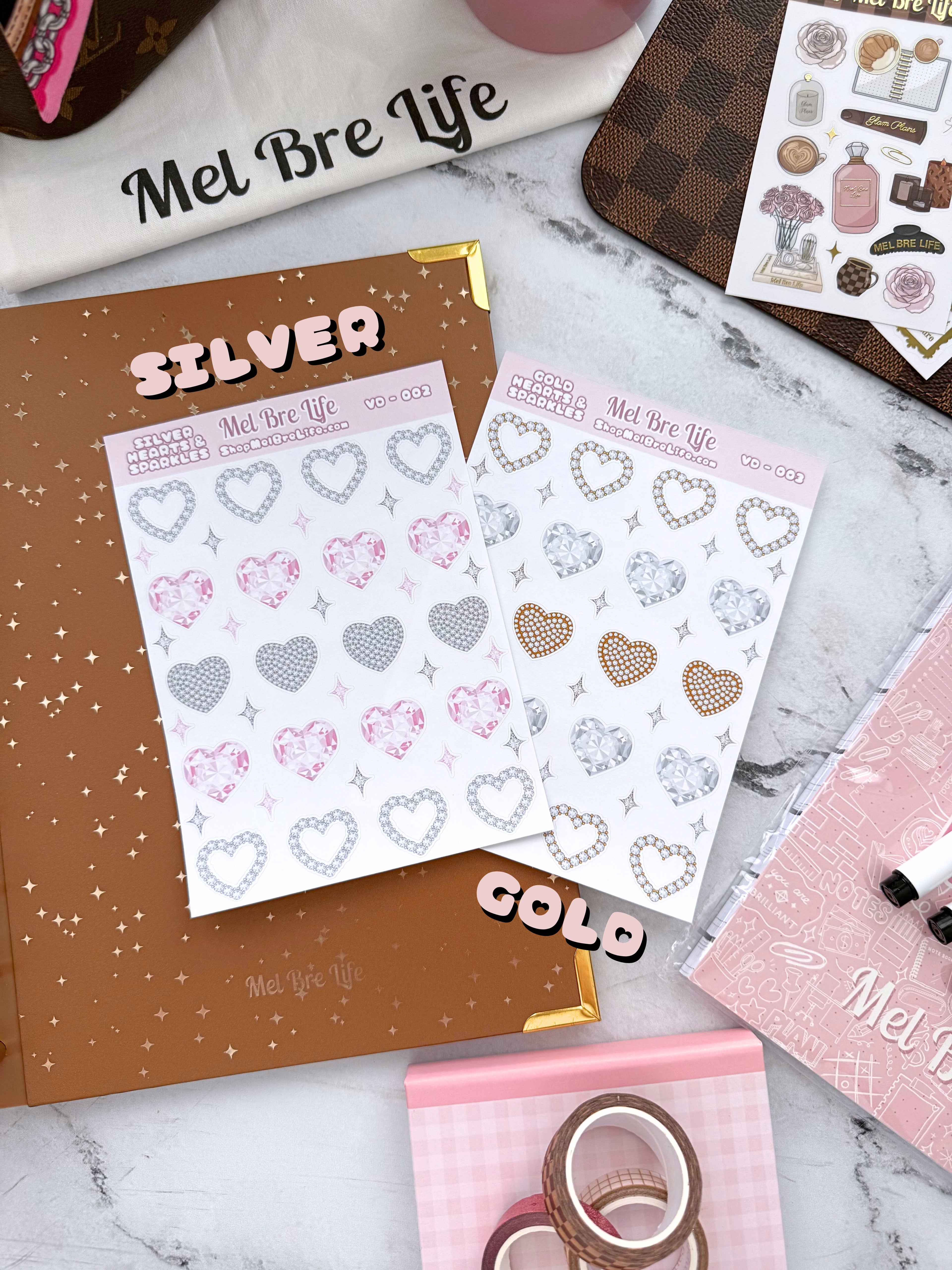 Sticker sheets with heart designs and 'Mel Bre Life' branding on a marble surface.