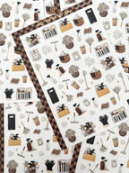 Clear matte glam planner sticker sheet with gold foil accents featuring cleaning supplies, baskets, sprays, and cozy home reset icons