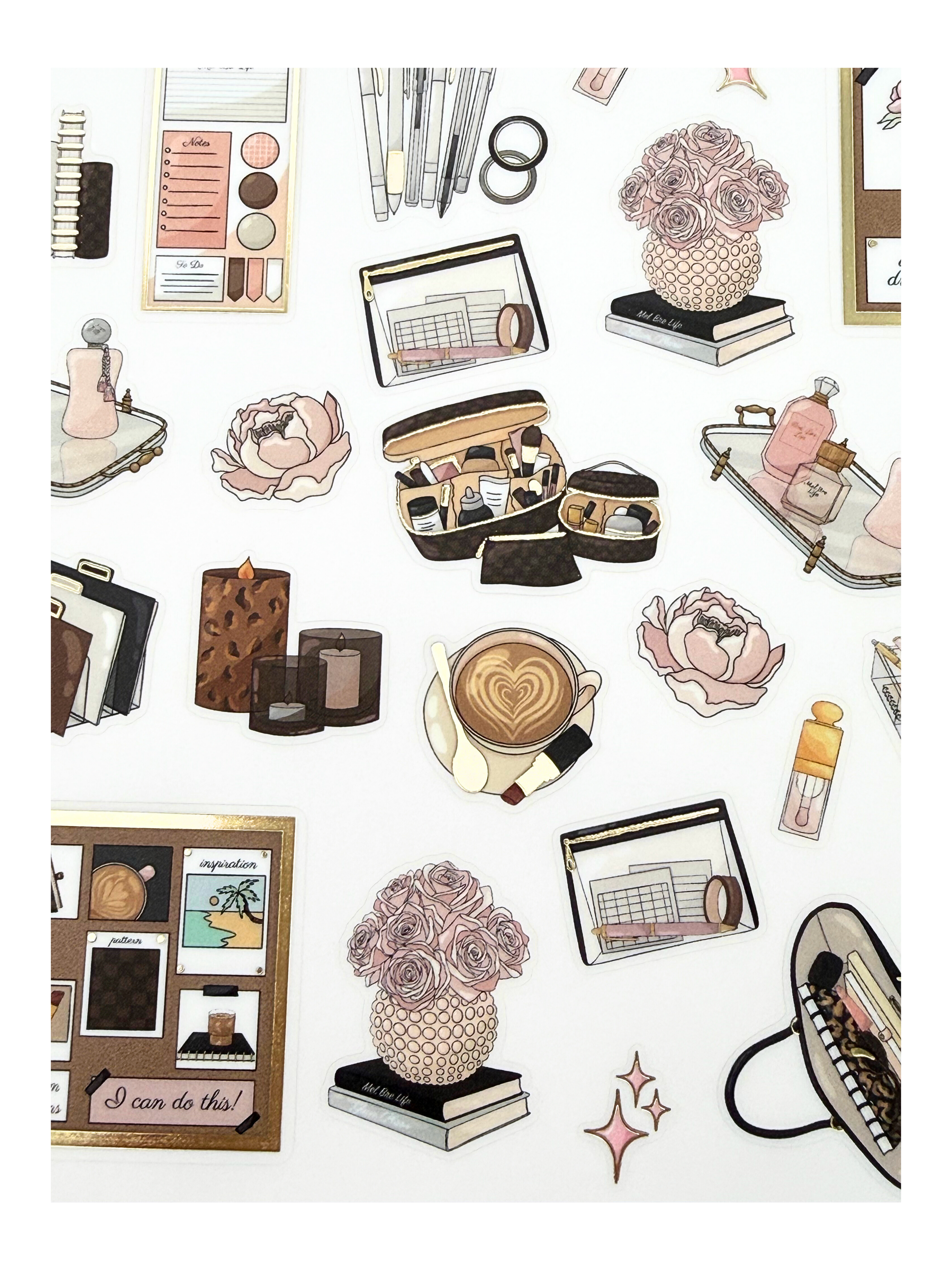 Clear matte glam planner sticker sheet with gold foil accents featuring everyday lifestyle icons, planners, bags, florals, and chic essentials